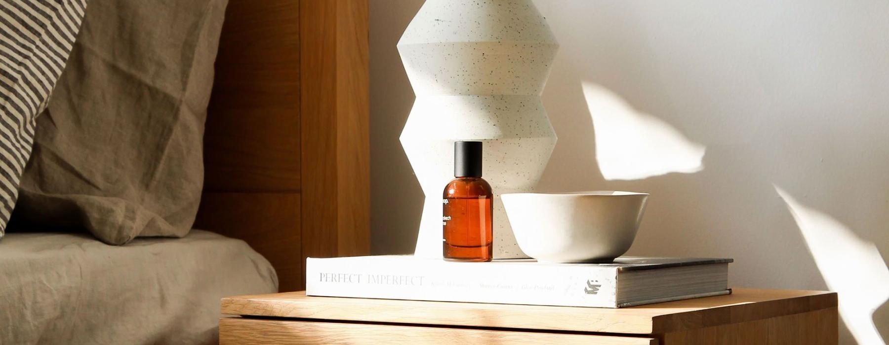 bedside table with lamp and bowl on a book